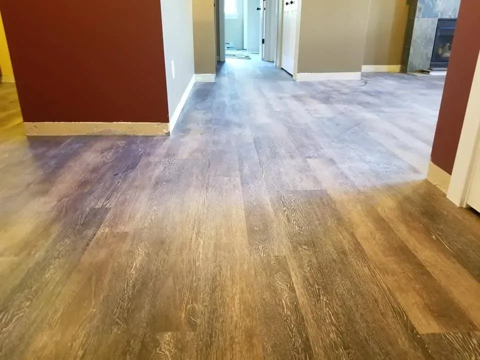 A living room with hardwood floors and a fireplace.