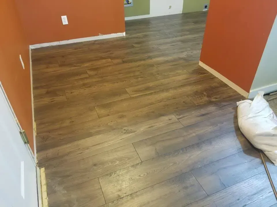 A room with a wooden floor and orange walls.