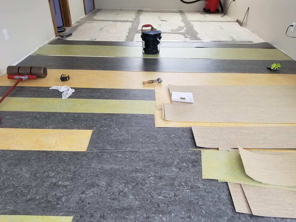 A room with a striped floor and a vacuum cleaner on the floor.