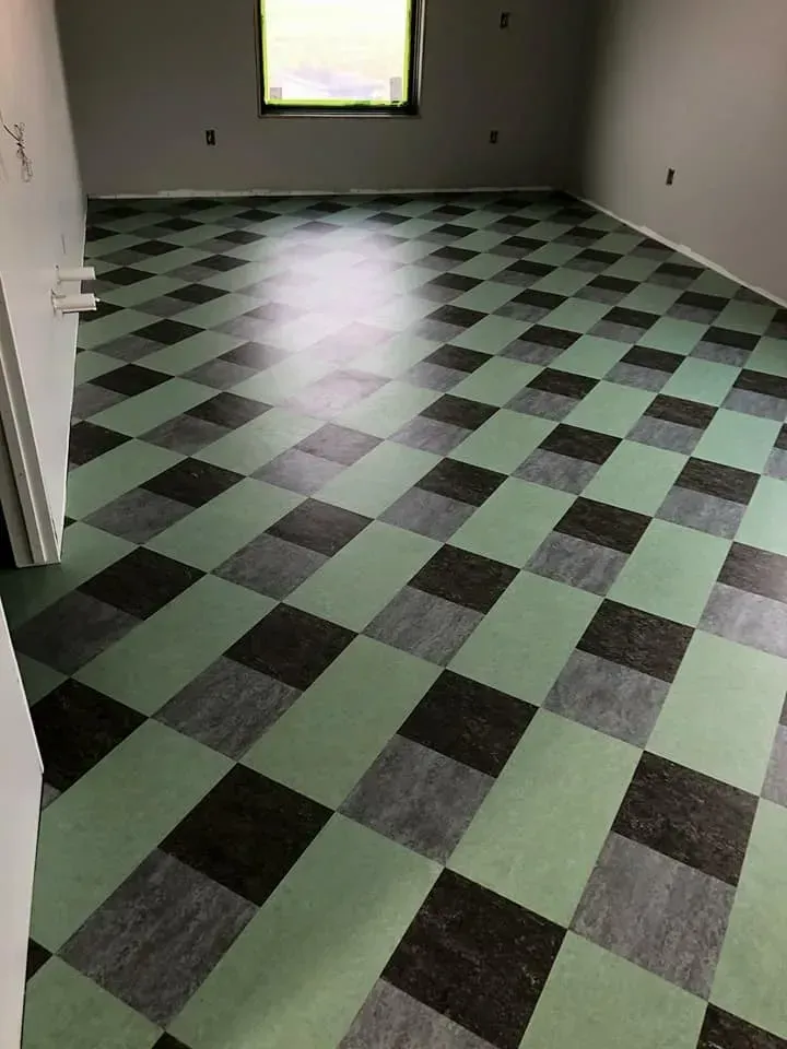 A room with a checkered floor and a window.