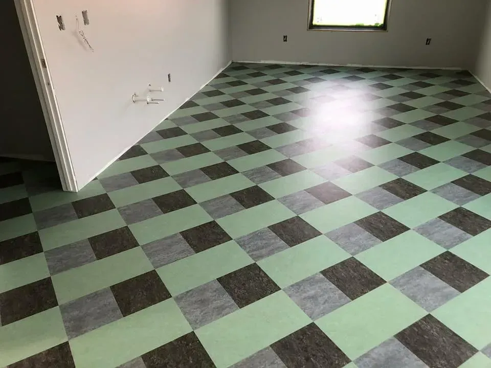 A room with a checkered floor and a window.