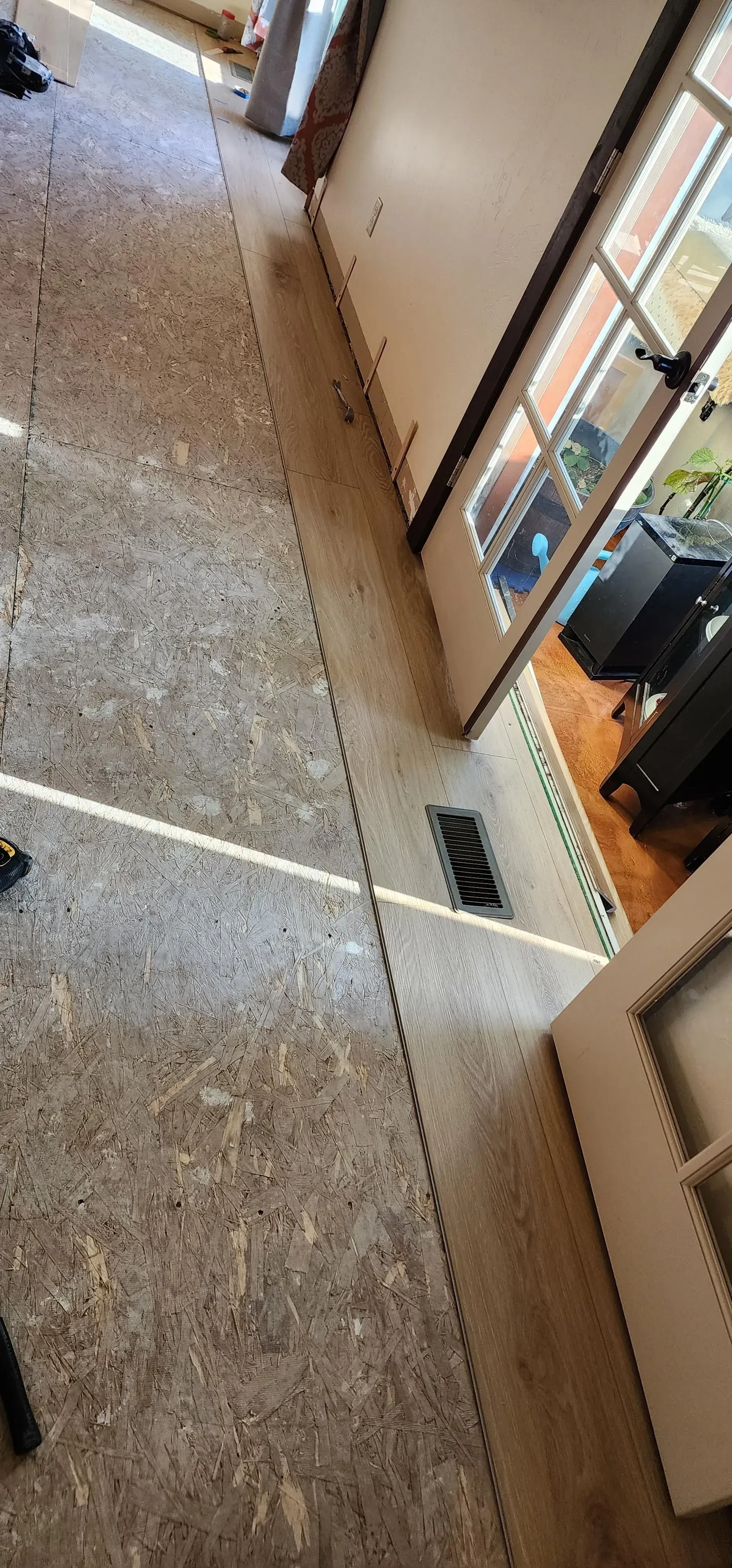 A hallway with a carpeted floor and a door in a house.