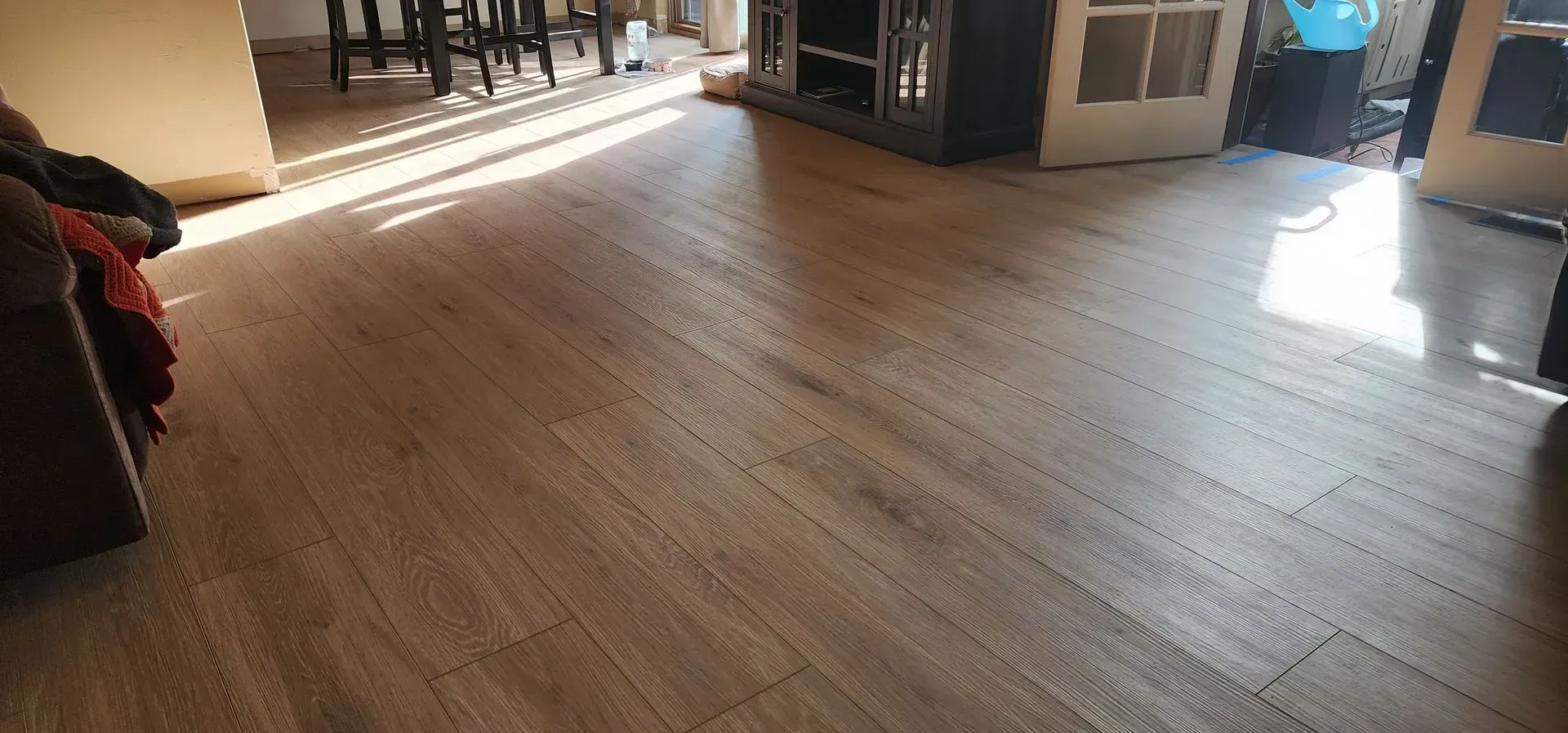 A living room with a wooden floor and a couch.