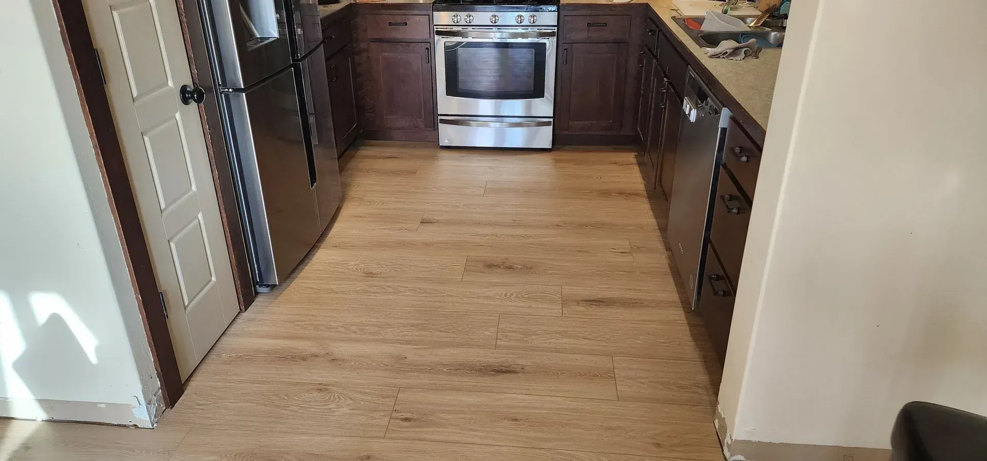 A kitchen with a wooden floor and a stove.