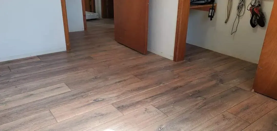 A room with a wooden floor and a door.