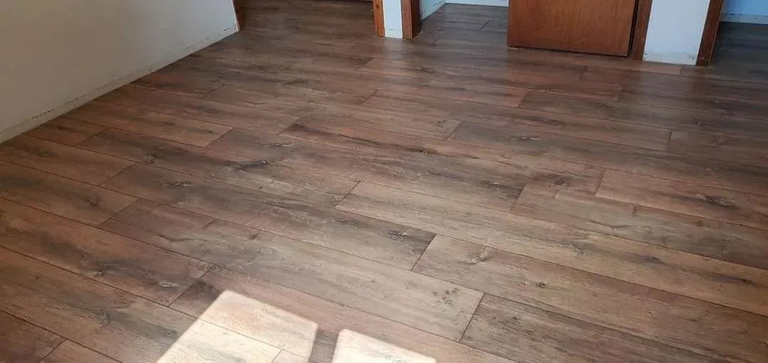 A room with a wooden floor and a door.