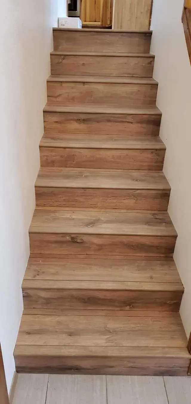 A set of wooden stairs leading up to the second floor of a house.