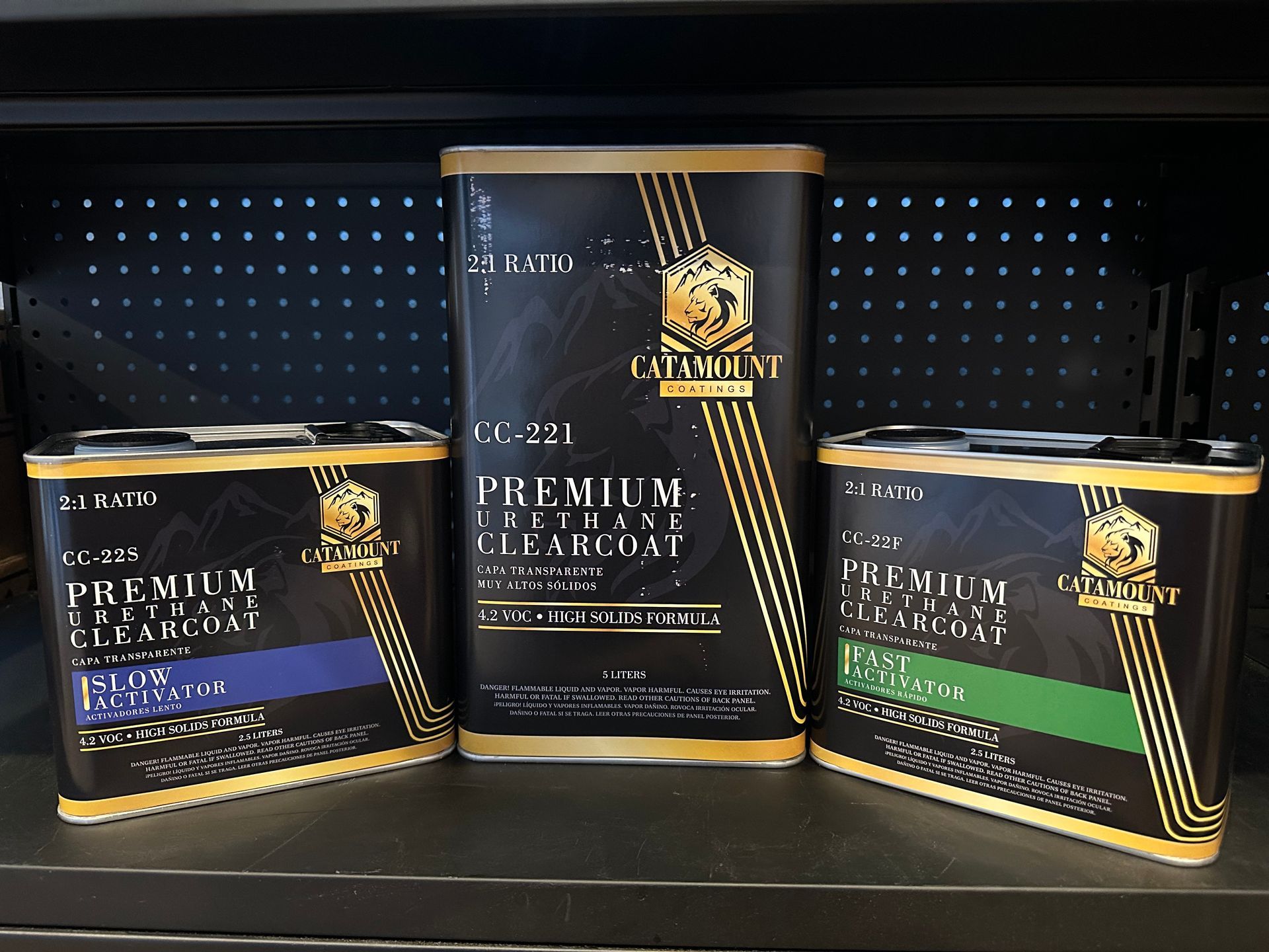 Three cans of cc-47 premium clearcoat activator on a shelf