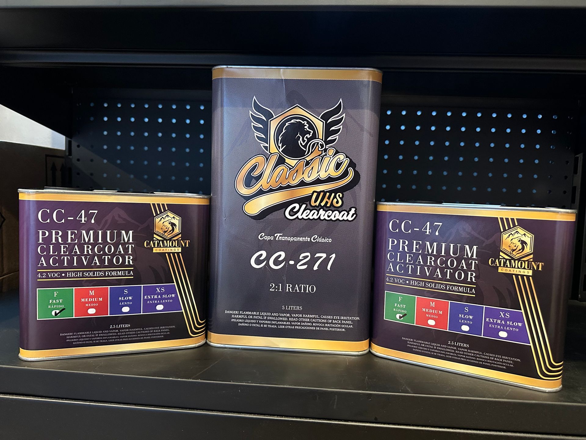 Three cans of cc-47 premium clearcoat activator on a shelf