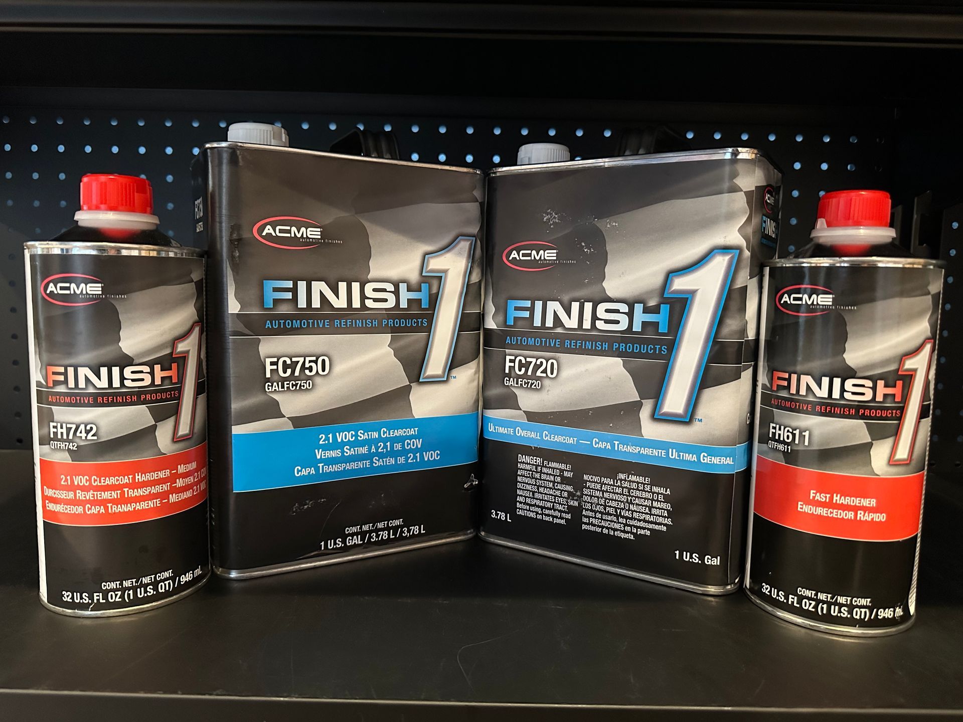 Four cans of finish 1 are sitting on a shelf