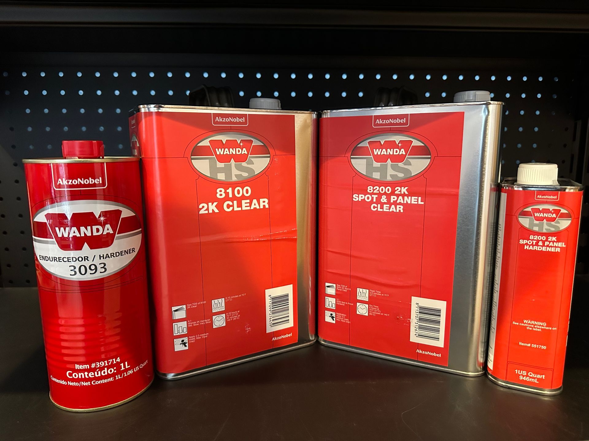 Three cans of wanda paint are sitting on a table.