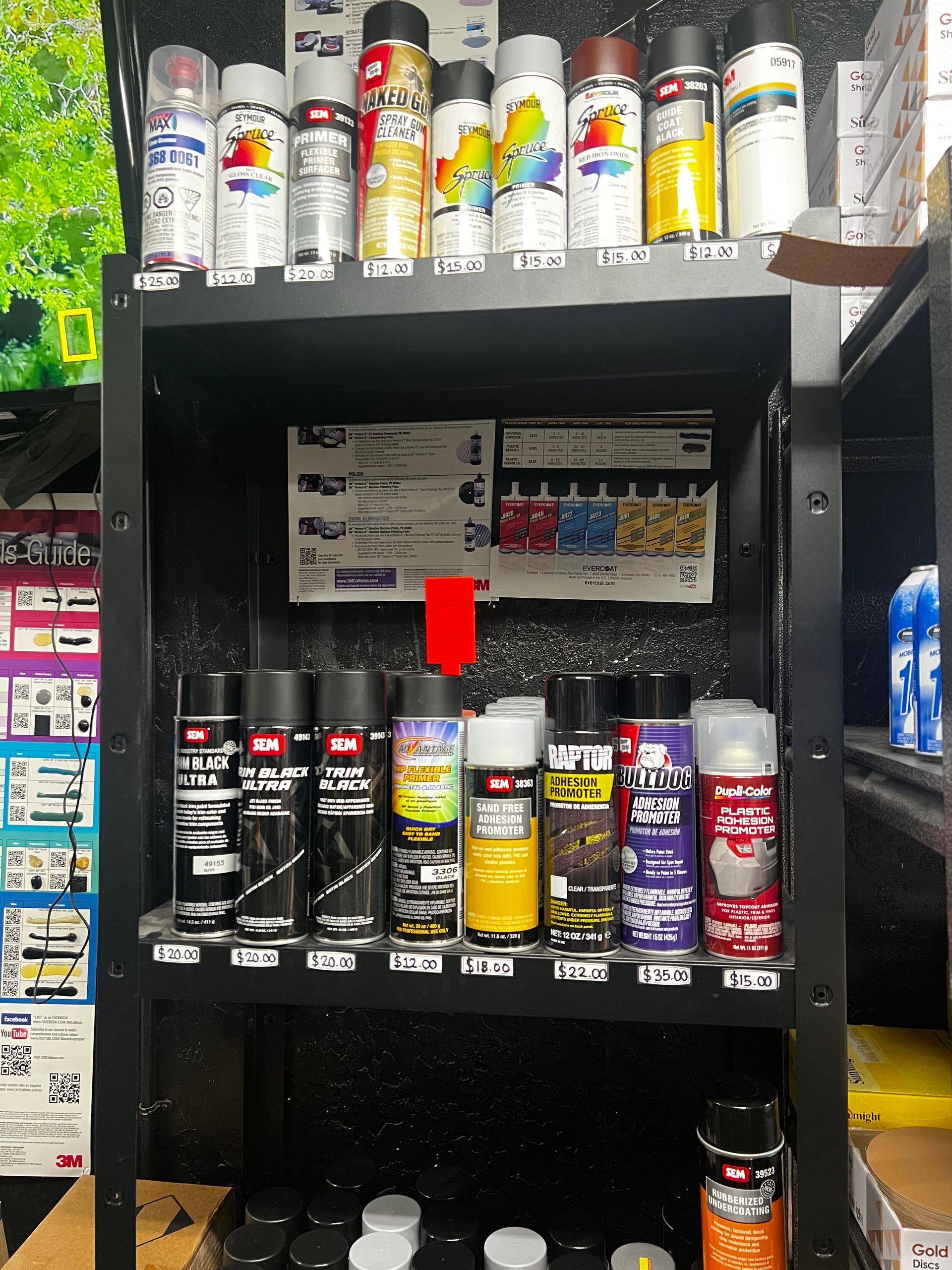 A bunch of spray paints are on a shelf in a store
