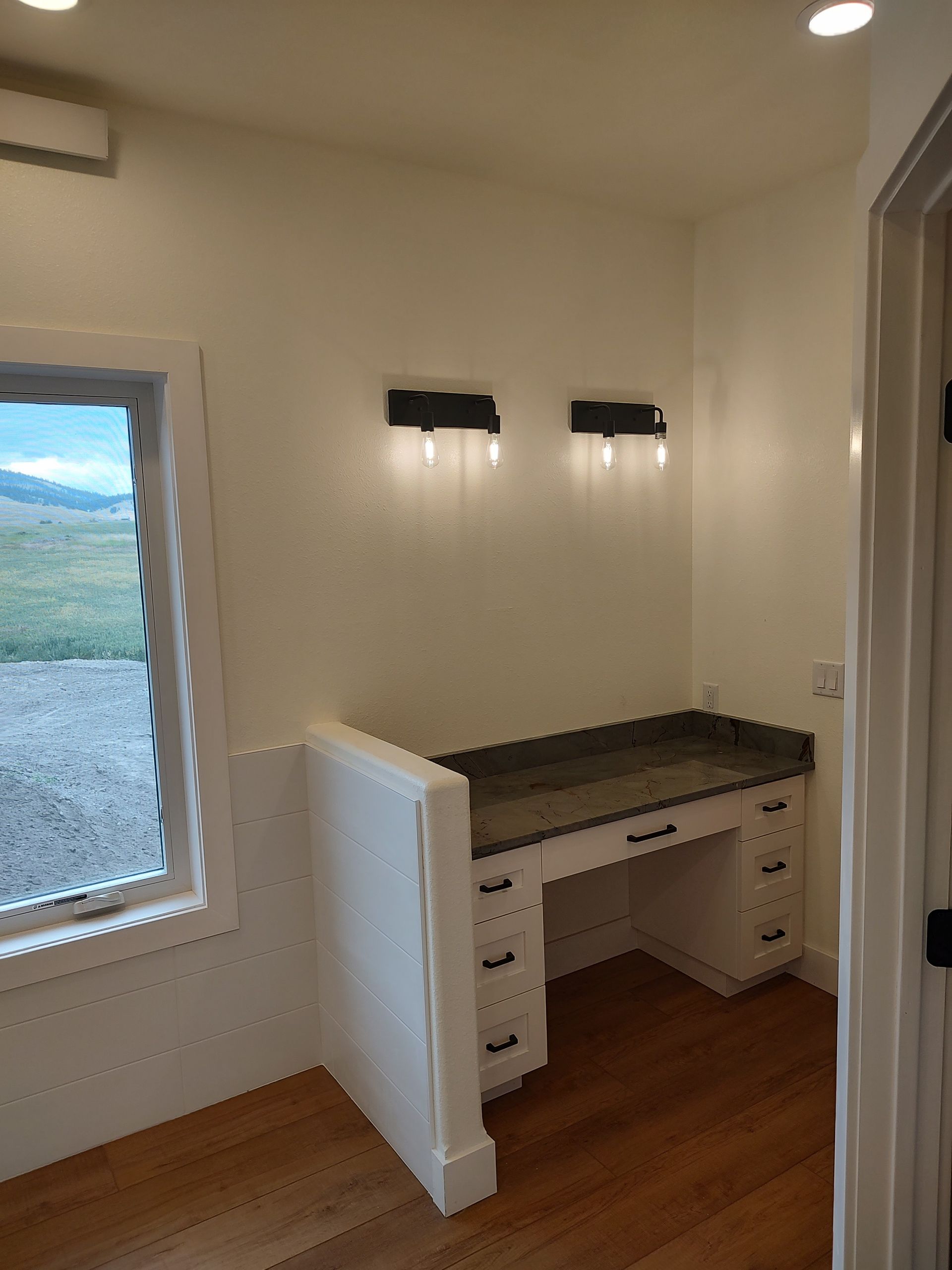 A room with a desk and a window in it