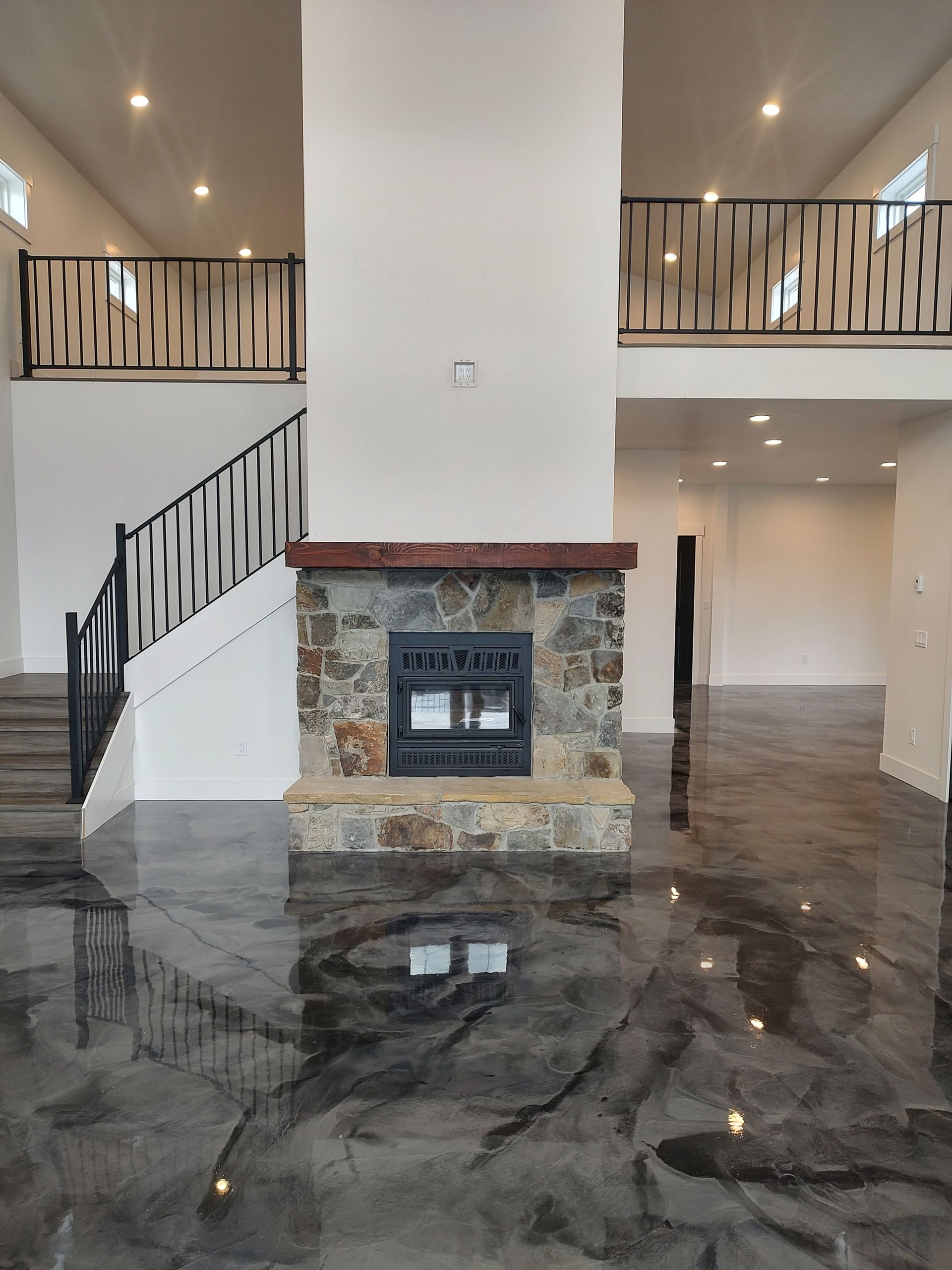 A living room with a fireplace and stairs