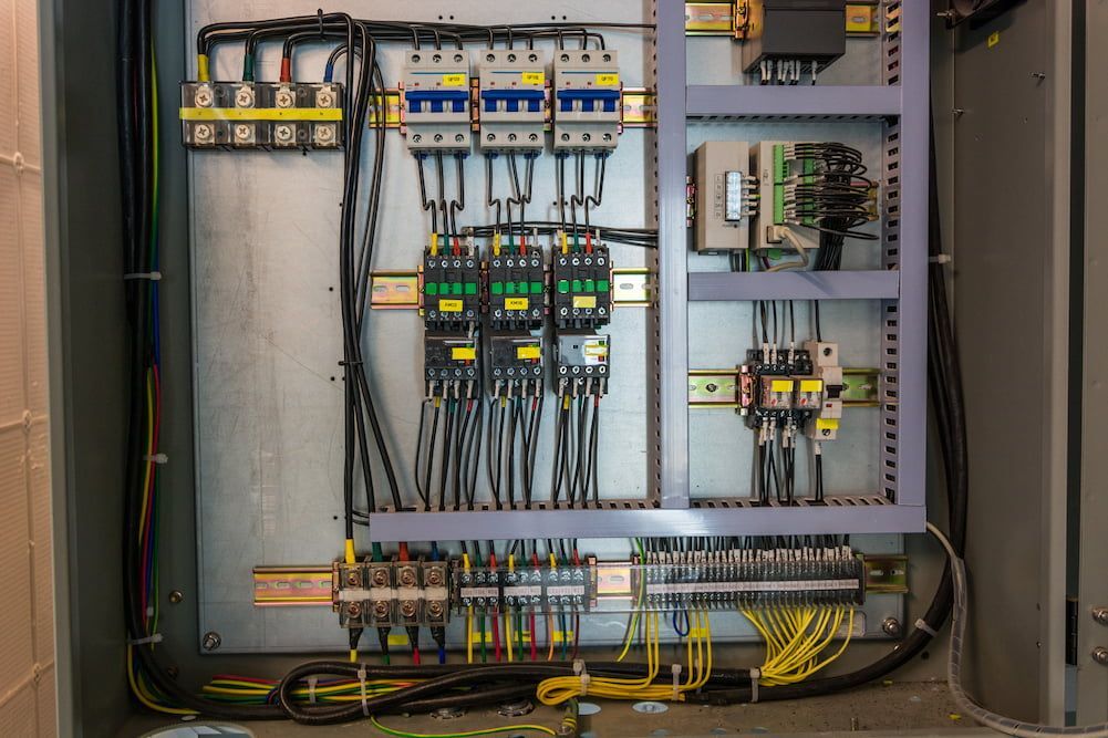 A Close up Of a Electrical Panel with A Lot of Wires Coming out Of It — Jason Wenta Electrical Services in Condon, QLD