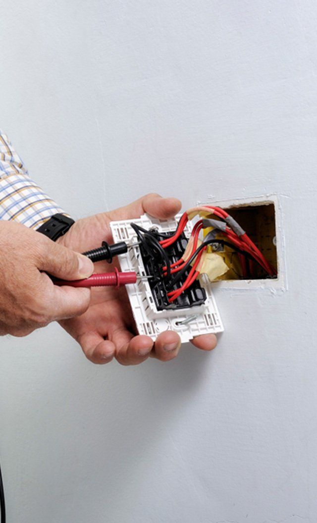 Electrician at Work on Switches and Sockets — Jason Wenta Electrical Services in Condon, QLD