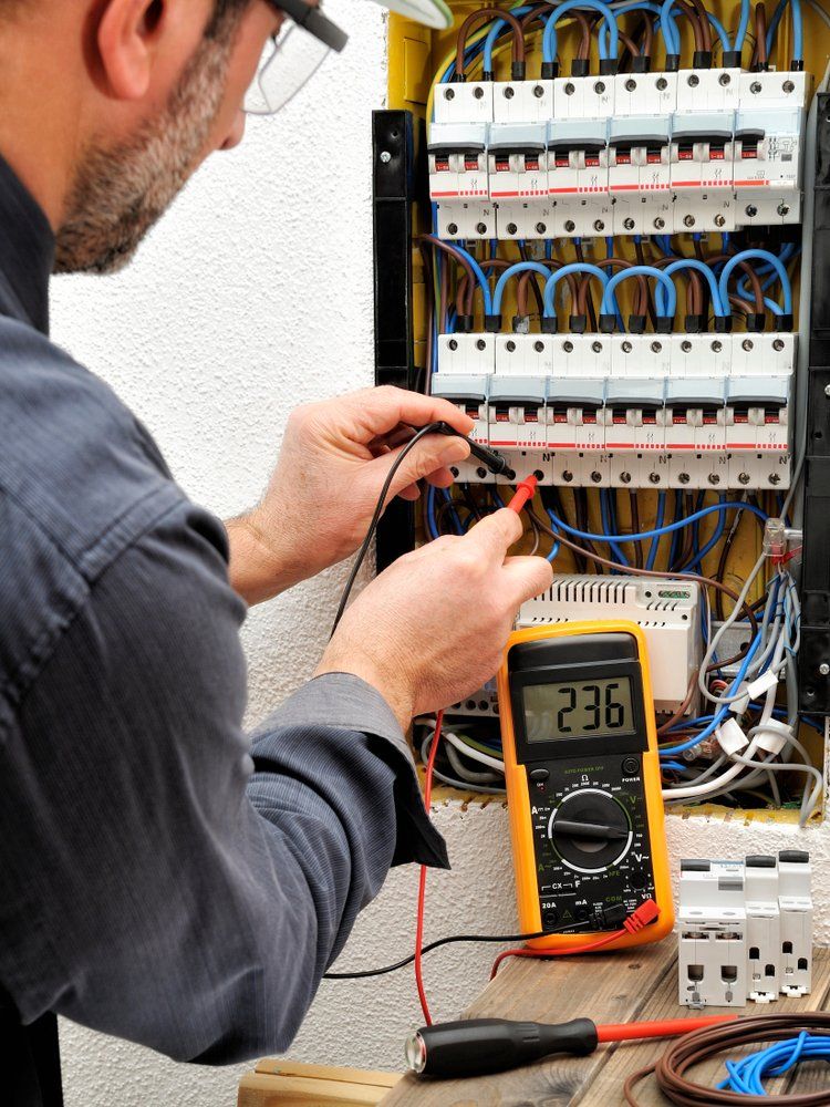 Technical Electrician Measures The Voltage of a Circuit Breaker — Jason Wenta Electrical Services in Condon, QLD