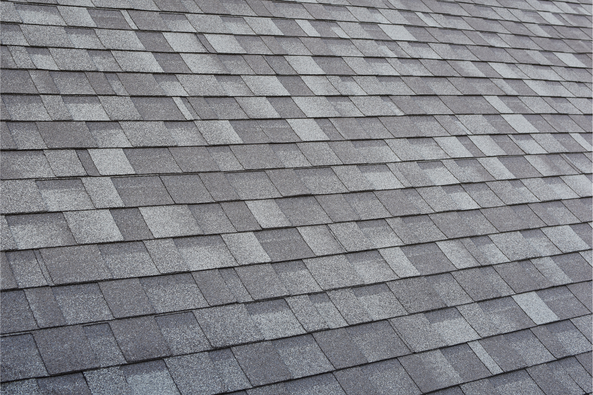 A close up of a roof with a lot of shingles on it.