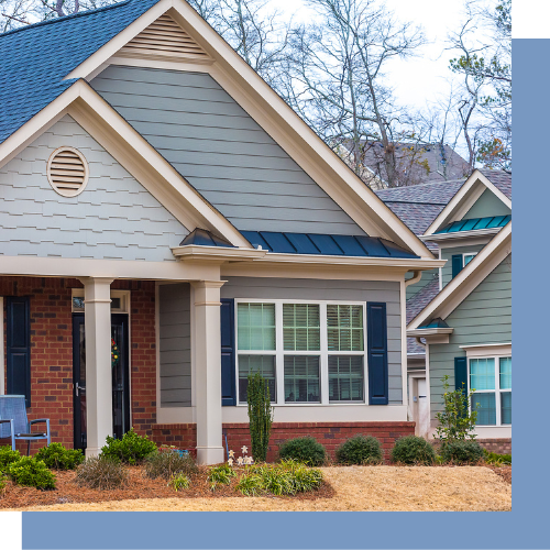 a house with a blue roof , white siding , and blue shutters .