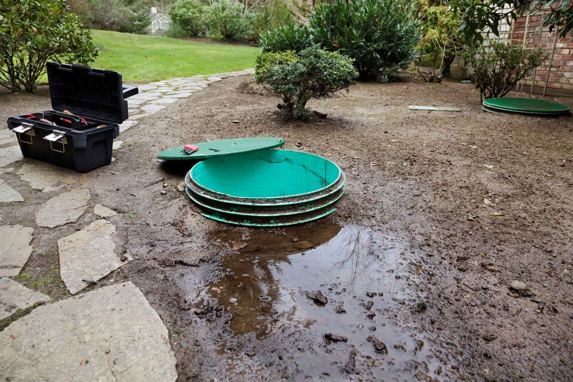 Residential septic system access lid exposed during septic system inspection.