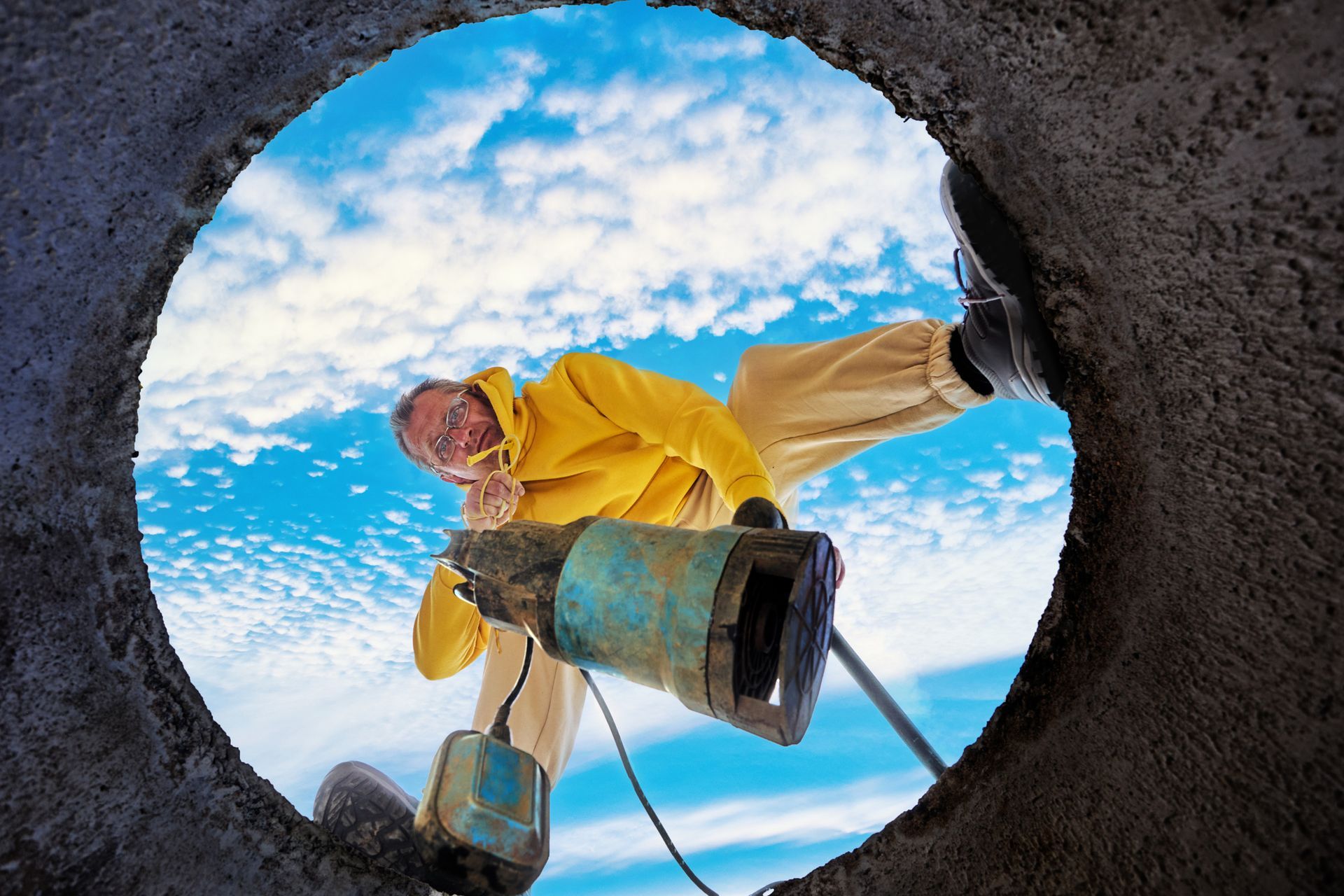 Bottom view of man immersing sewage pump into septic tank. Bottom view of man immersing sewage pump into septic tank.