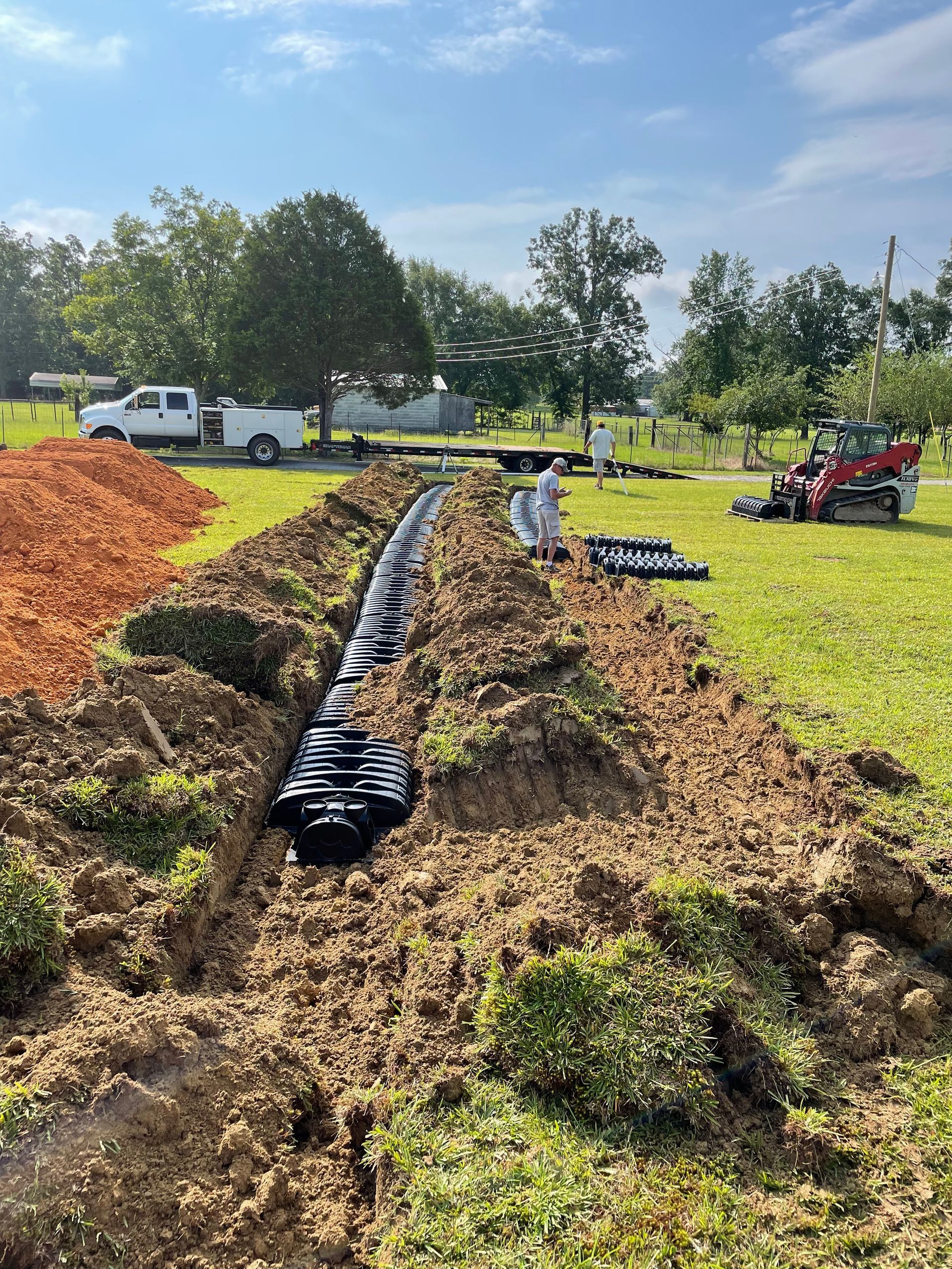 A septic system is being installed in a field.