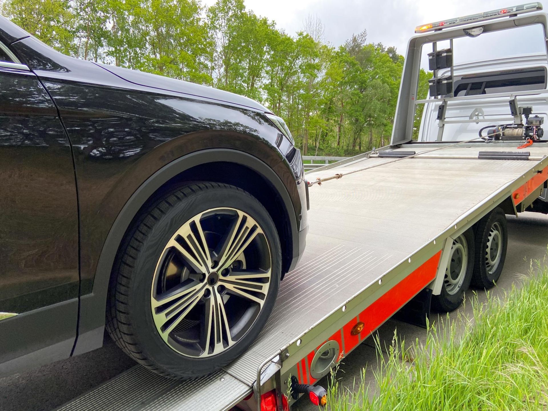 A car is being towed by a tow truck.