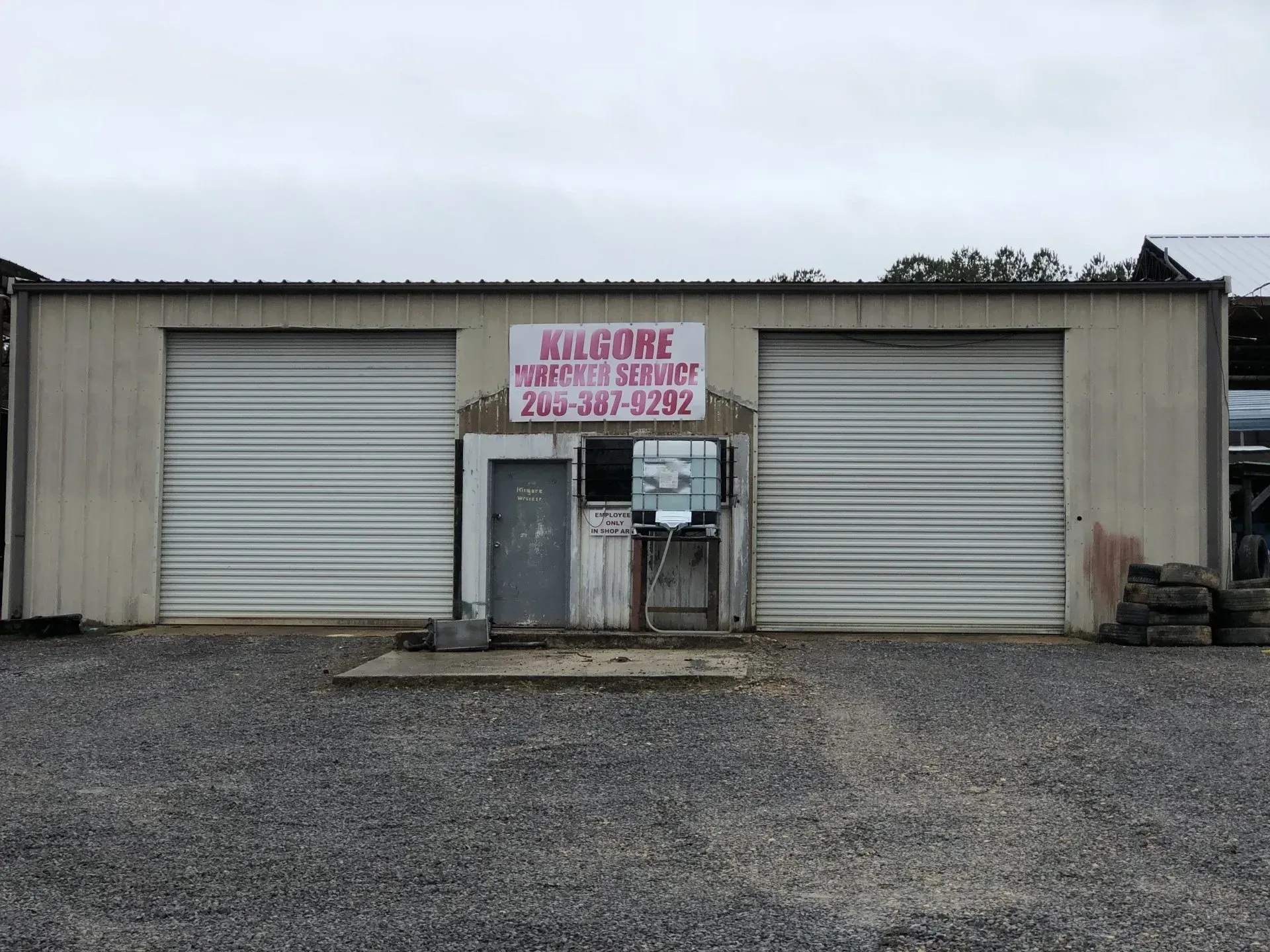 A building with a sign that says welcome tire service.