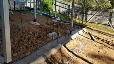 A Fence Is Being Built in The Backyard of A House — Conan The House Lifter In Townsville, QLD