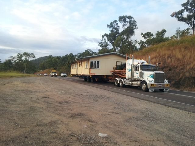 A Semi Truck Is Carrying a House Down the Road — Conan The House Lifter In Townsville, QLD — Conan The House Lifter In Townsville, QLD