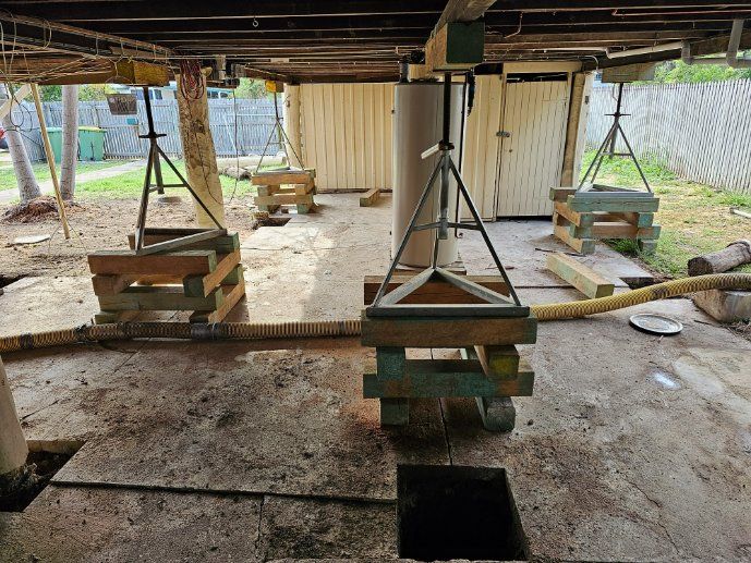 A Wooden Structure Is Being Built Under a House — Conan The House Lifter In Townsville, QLD