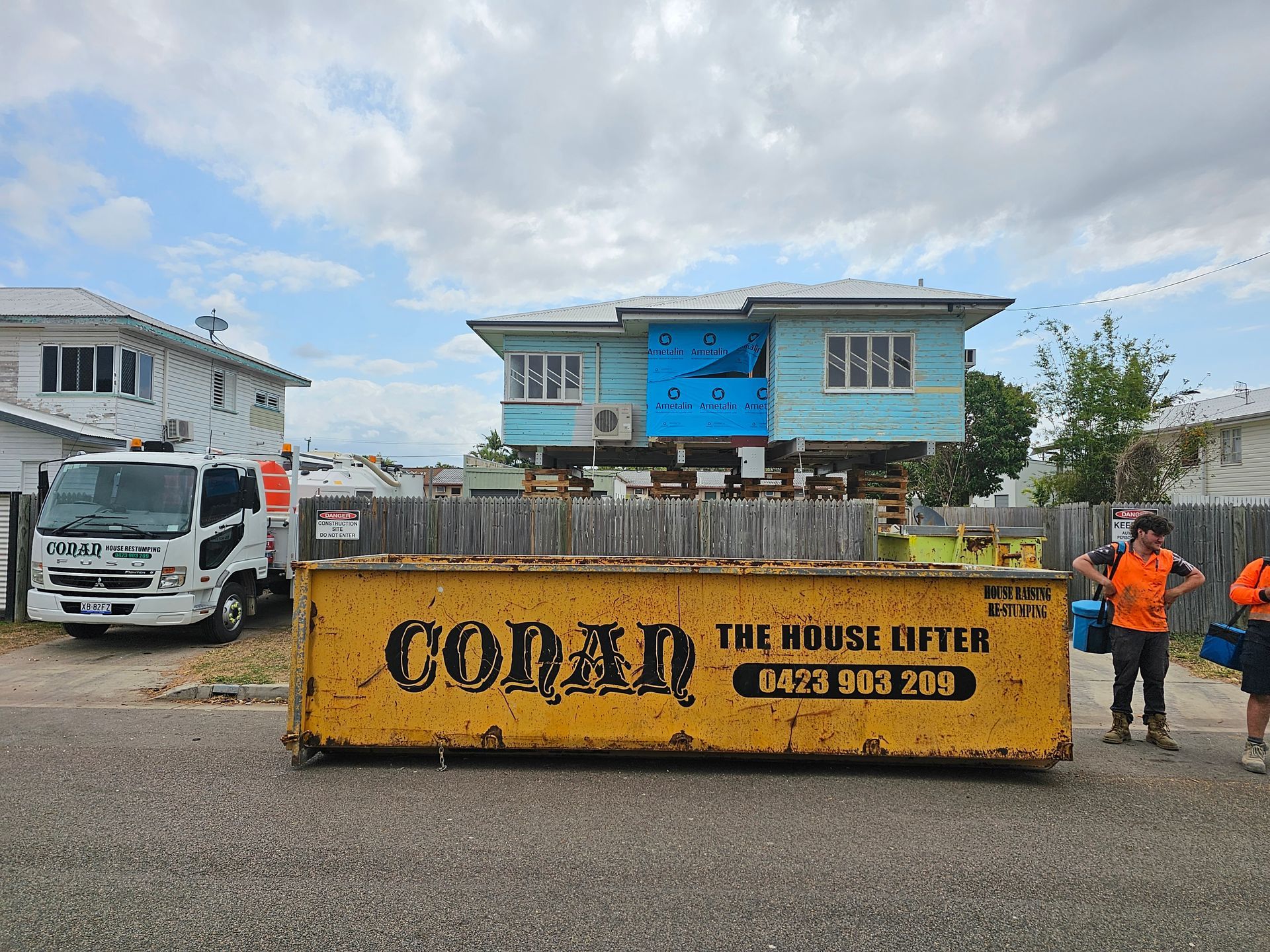 A Dump truck Carrying a house on its bed, Showcasing a Unique Transportation Method for Moving Homes — Conan The House Lifter In
