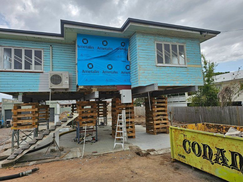 A Blue House Is Being Built on Stilts — Conan The House Lifter In Townsville, QLD