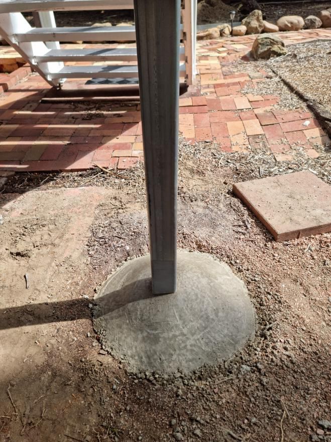 A Metal Pole Is Sitting on Top of A Concrete Base — Conan The House Lifter In Townsville, QLD