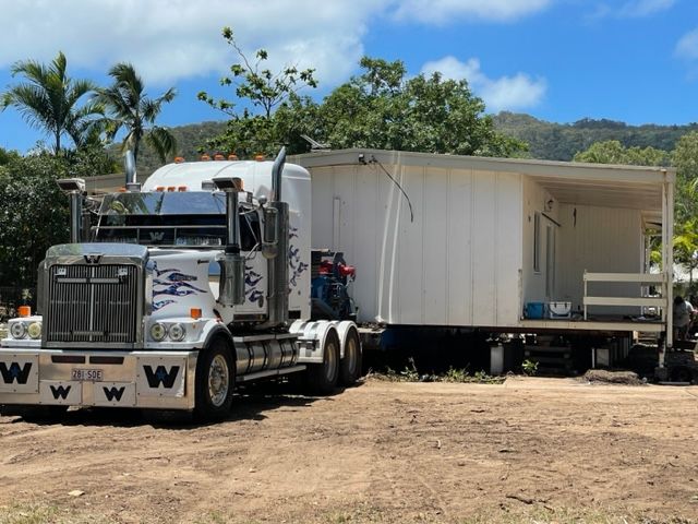 A Semi Truck Is Carrying a House on A Trailer — Conan The House Lifter In Townsville, QLD