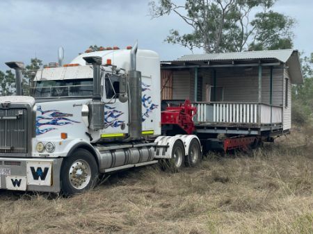A Semi Truck Is Pulling a Small House on A Trailer — Conan The House Lifter In Townsville, QLD