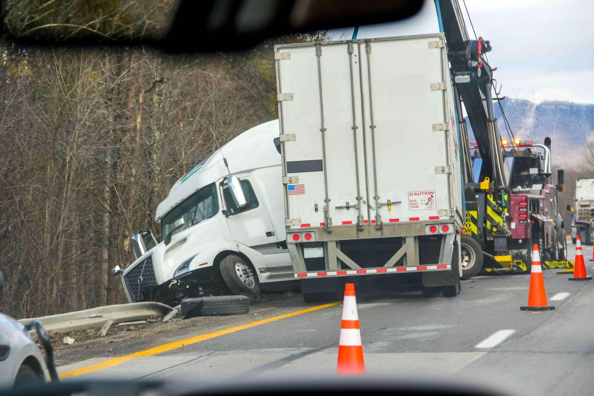 A picture of a semi-truck collision on the side of a highway for this section Trucking Accidents.