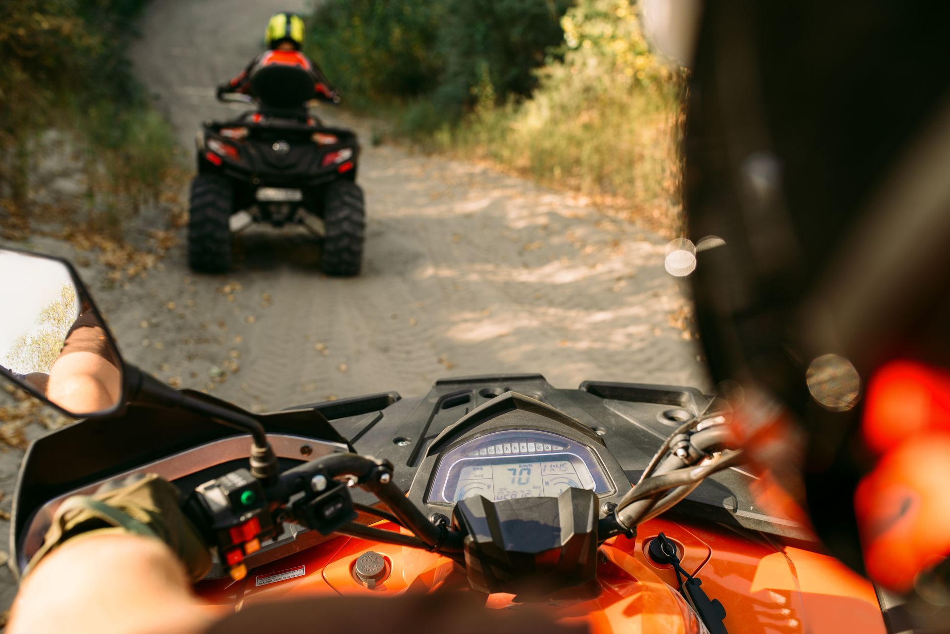 An example picture of a shoulder view ATV driver tailing another ATV driver. Clicking this picture takes you to ATV Accidents.