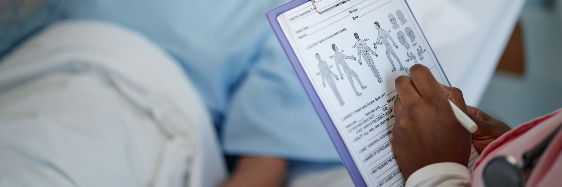 Medical professional reviewing a patient chart during a healthcare evaluation after an incident