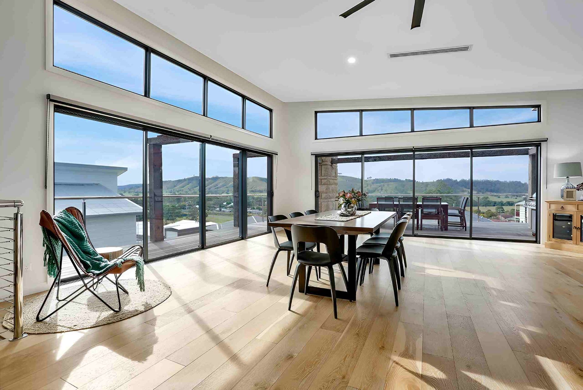 A Living Room With A Dining Table And Chairs And A Large Window — A & C Classic Window Tinting In Cessnock, NSW