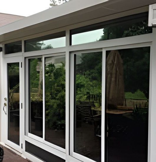 A House With A Lot Of Windows And A Patio In The Background — A & C Classic Window Tinting In Maitland Vale, NSW