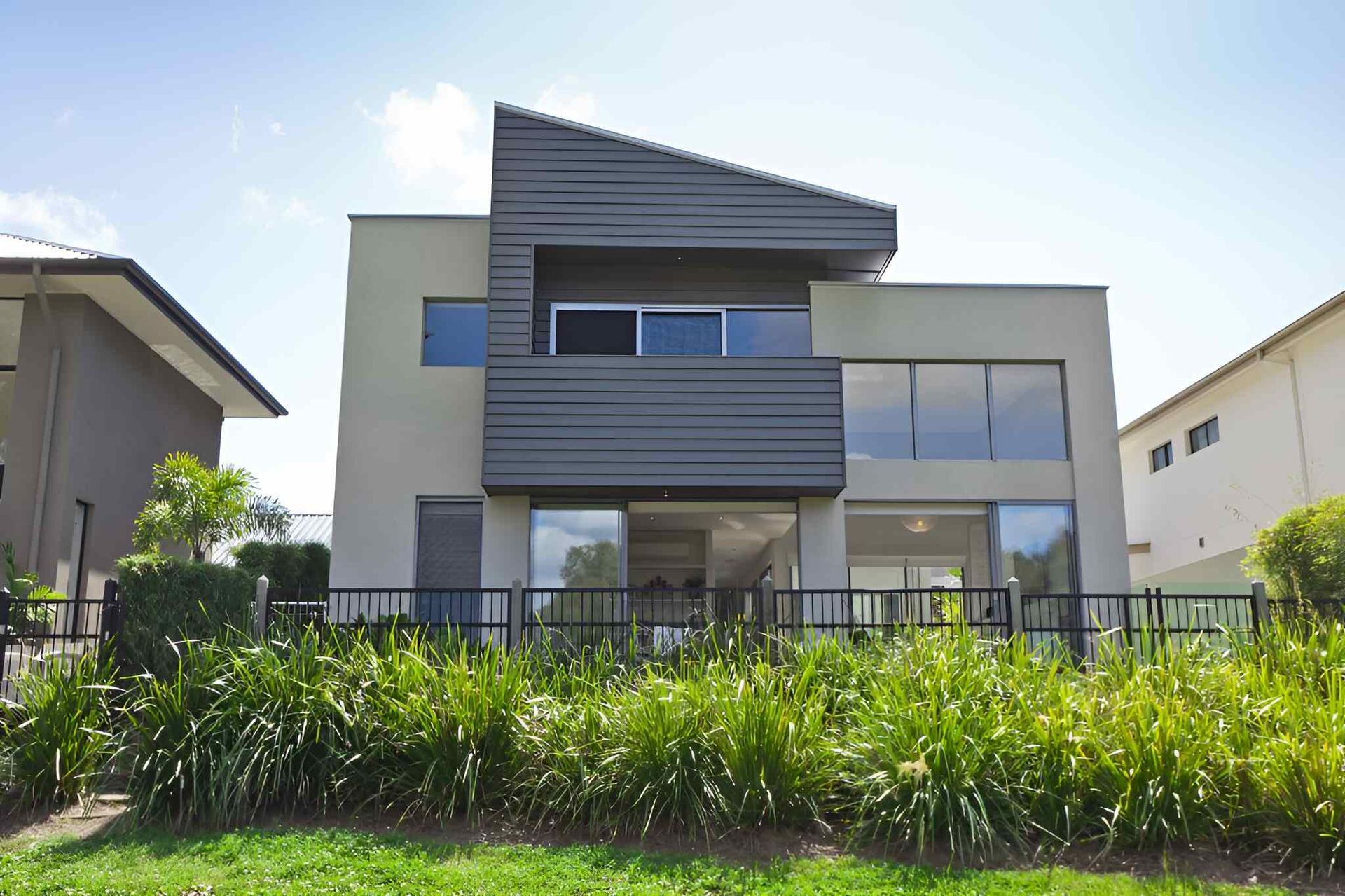 A House With A Lot Of Windows And A Fence Around It — A & C Classic Window Tinting In Maitland Vale, NSW