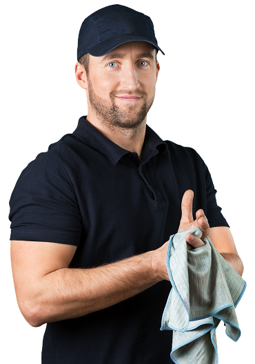 A person in a dark uniform and cap smiling while holding a cleaning cloth | Pro-Tec Auto Care
