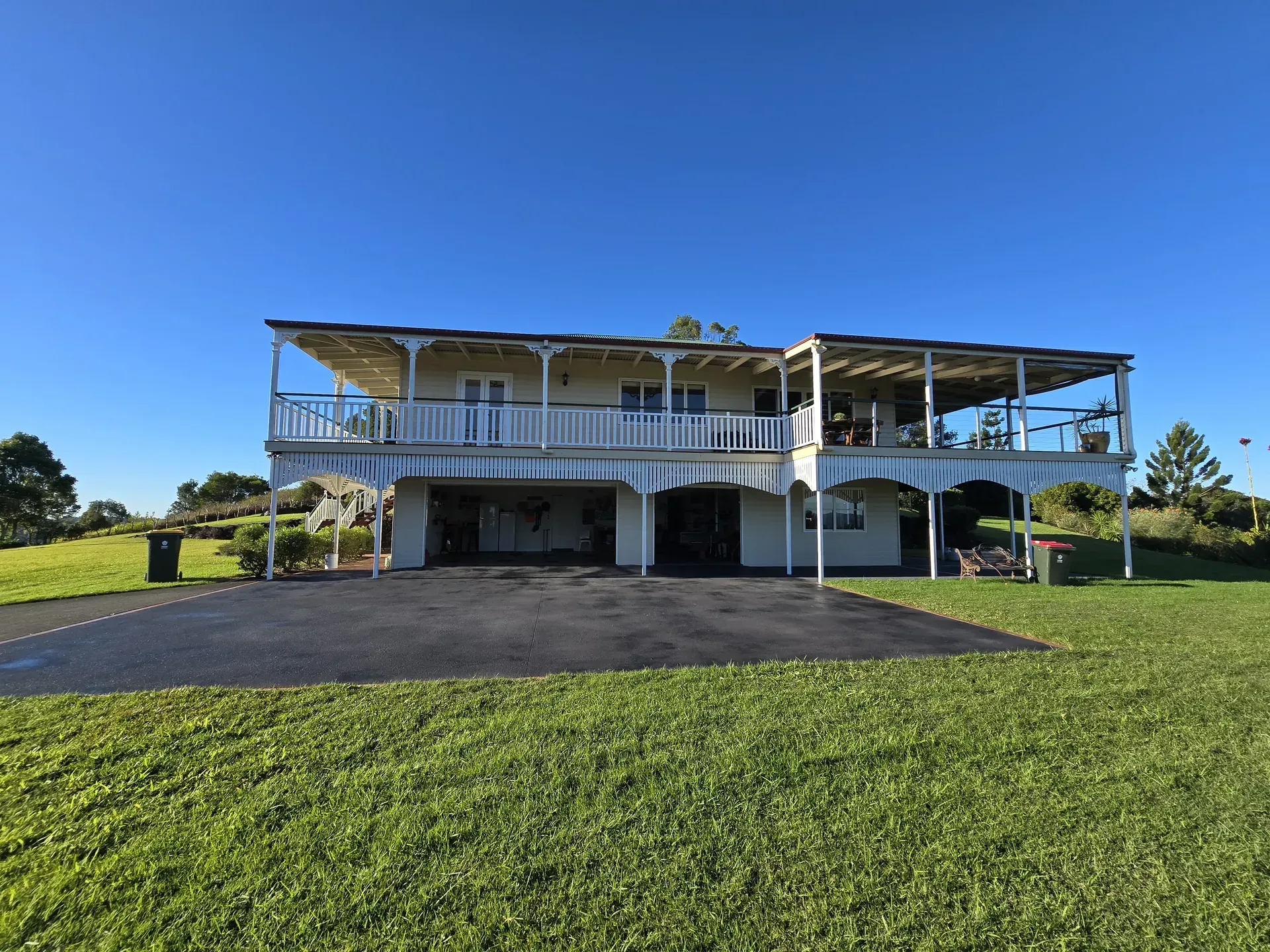 Two Workers Smoothing Wet Concrete With Trowels — Restoradrive in Tweed Heads, NSW