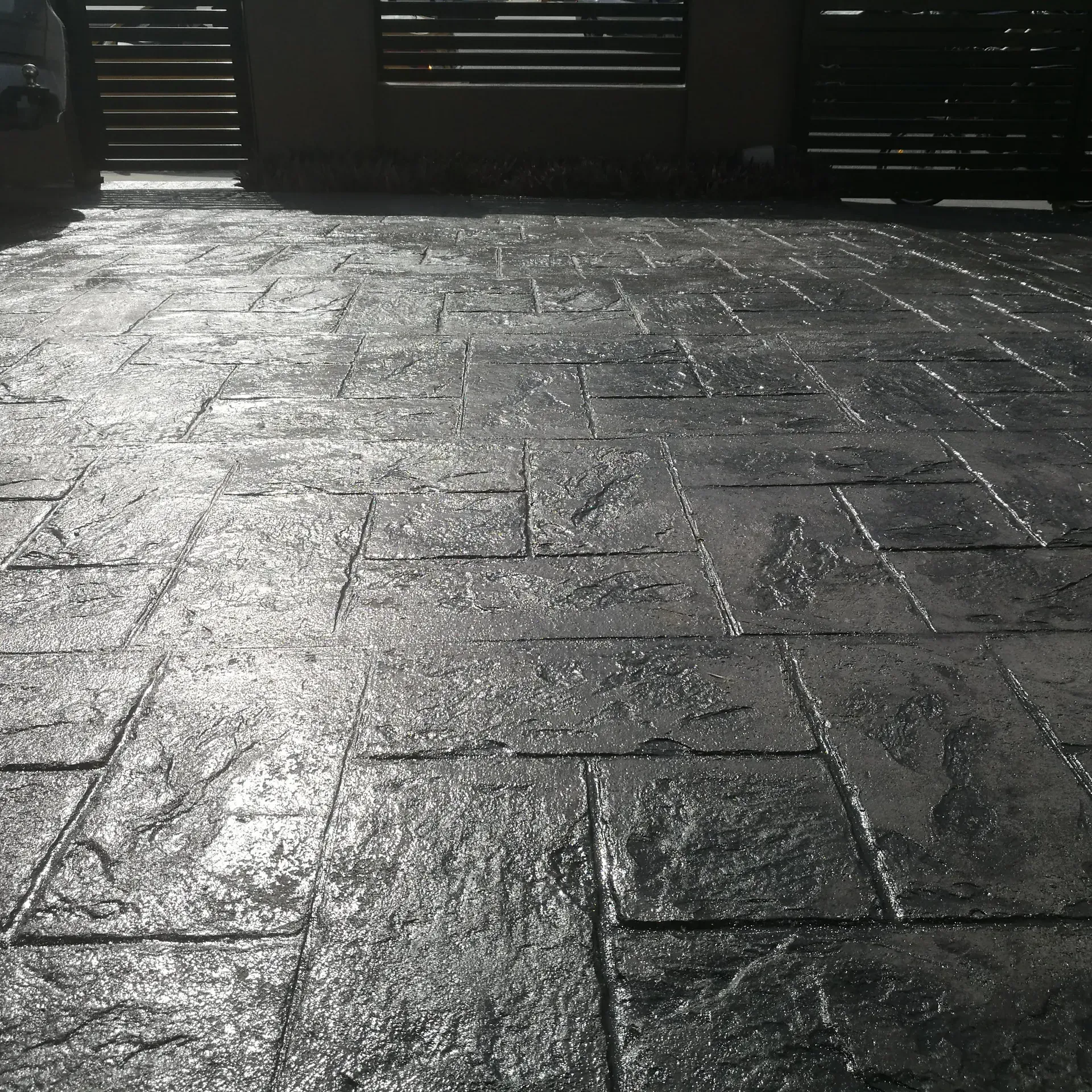 Workers Applying Beige Epoxy Flooring to a Concrete Surface, Using a Roller and Squeegee — Restoradrive in Byron Bay, NSW