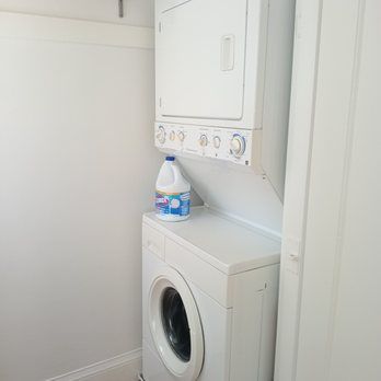A washer and dryer are stacked on top of each other in a laundry room.
