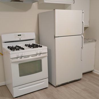 There is a stove and a refrigerator in the kitchen.