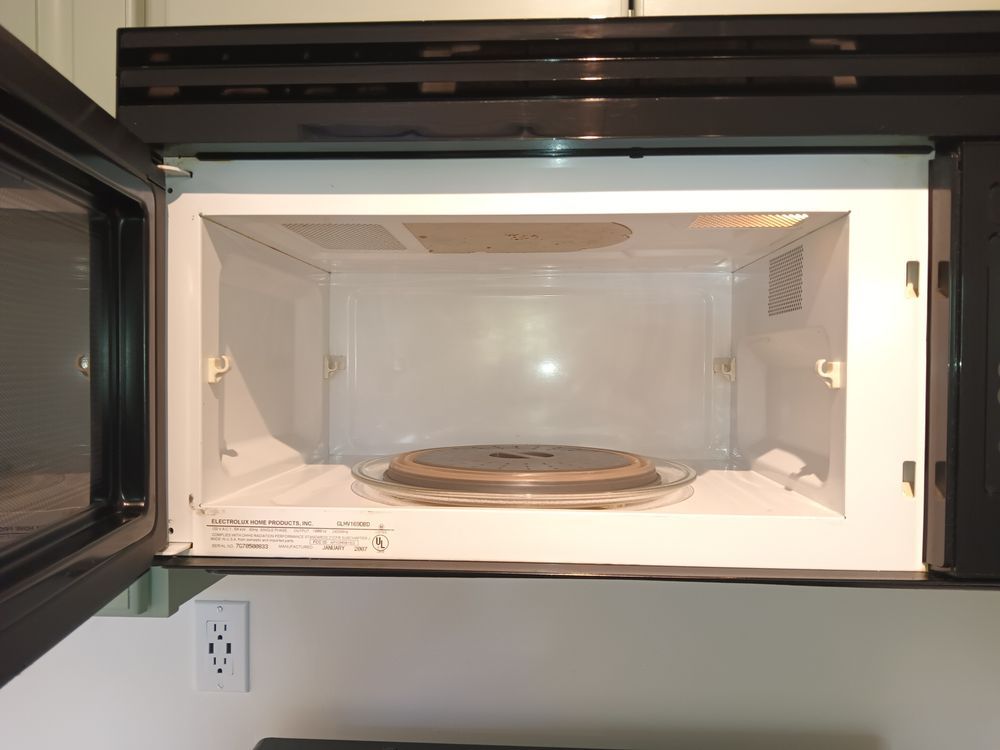 The inside of a microwave oven with the door open