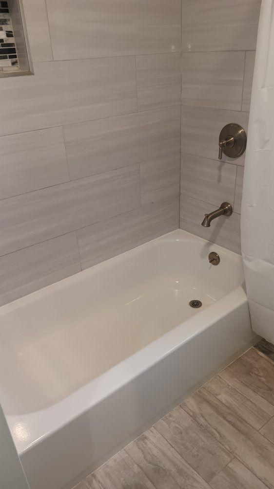 A bathroom with a bathtub and a shower.