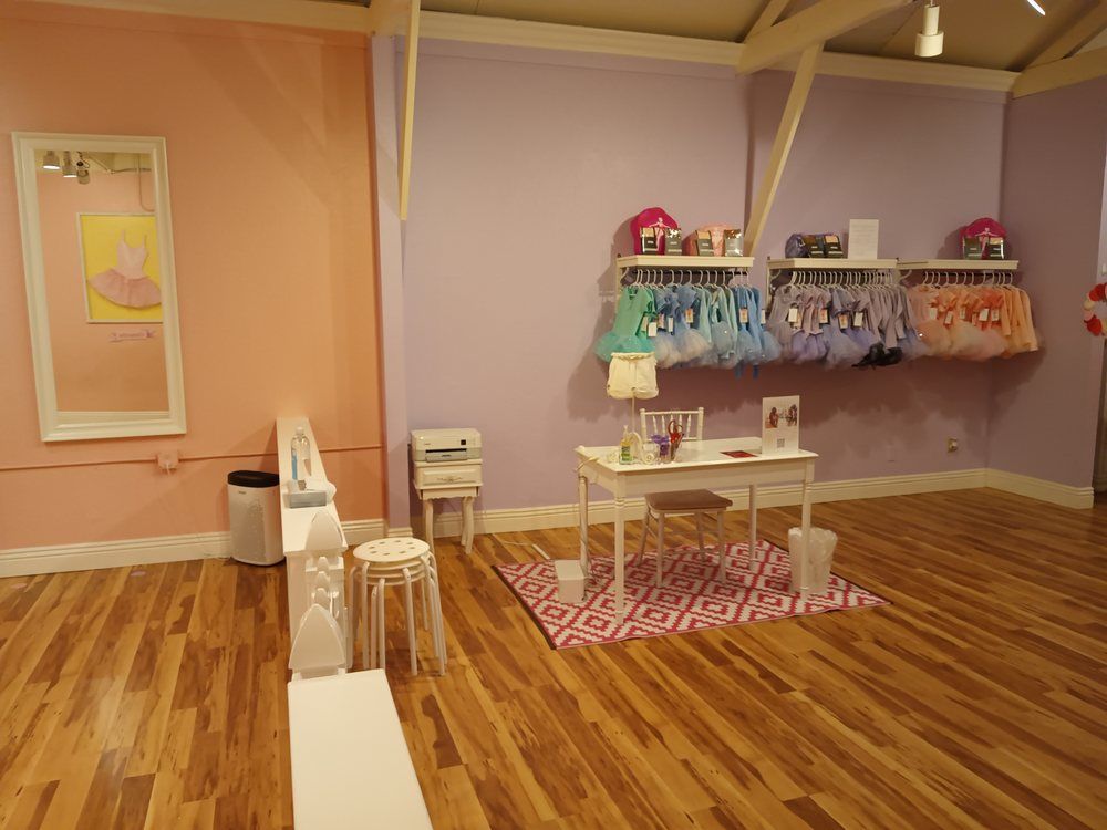 A room with wooden floors and pink and purple walls